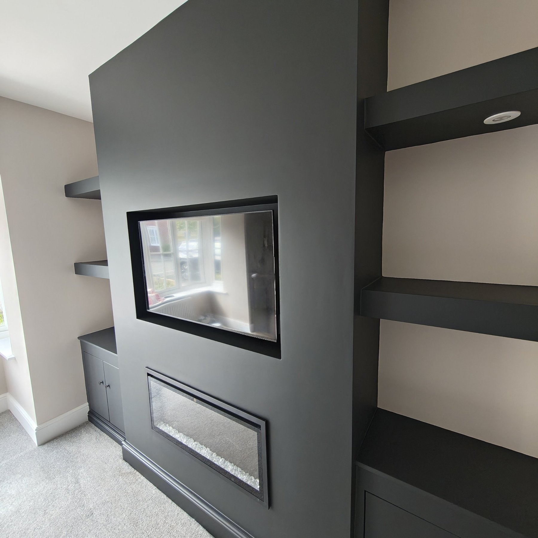 Charcoal painted media wall with floating shelves, Abergele
