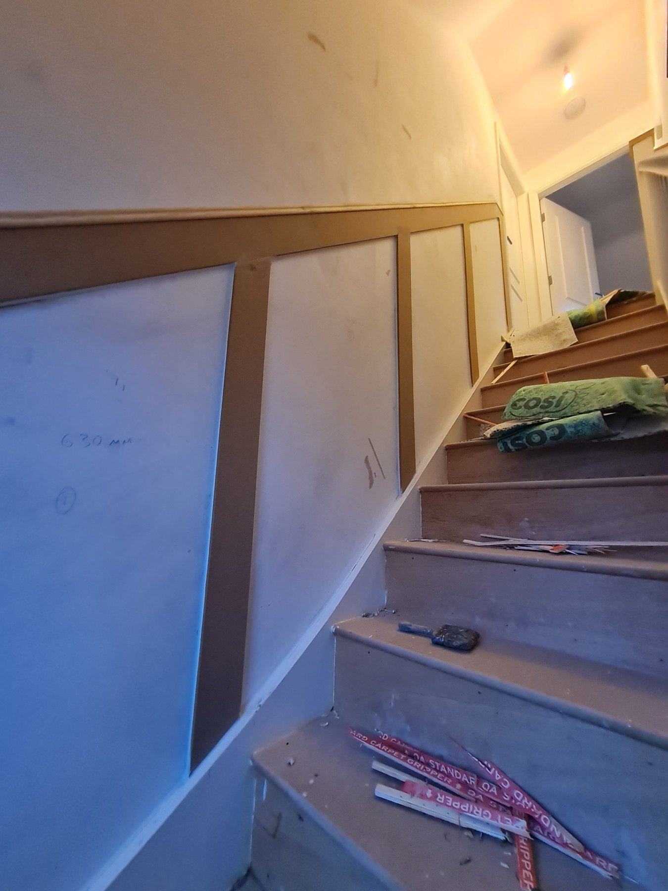 Newly fitted staircase wall panelling before painting, Abergele
