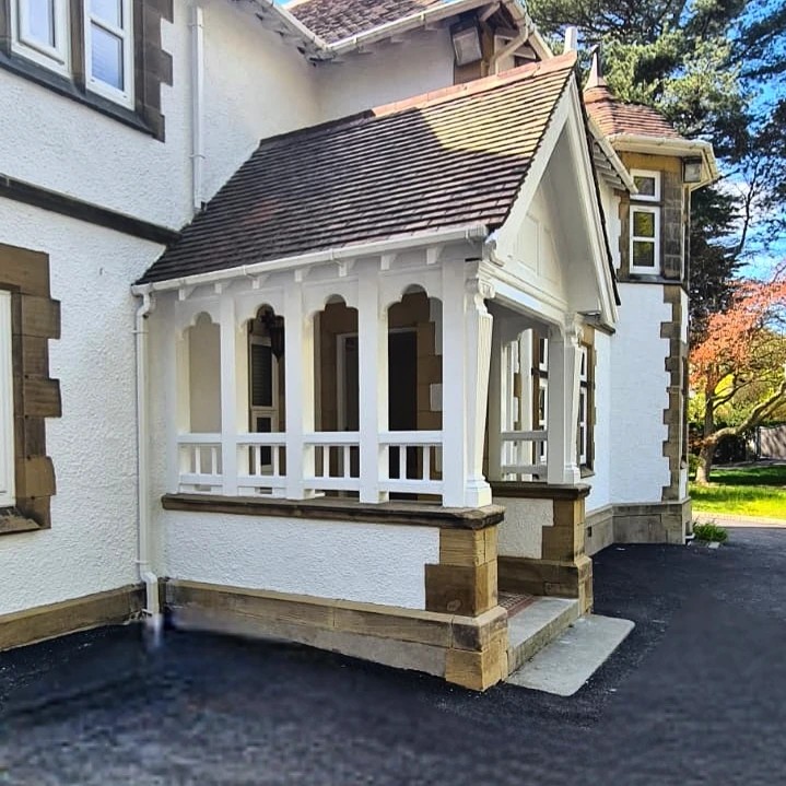 Redecorated porch with white painted columns and woodwork at Hillgrove House, Bangor