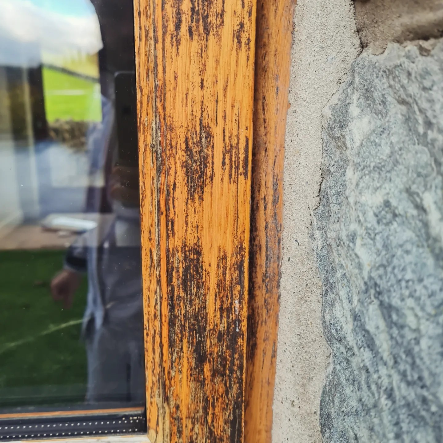 Weathered oak frame being sanded back during preparation, Betws-y-Coed