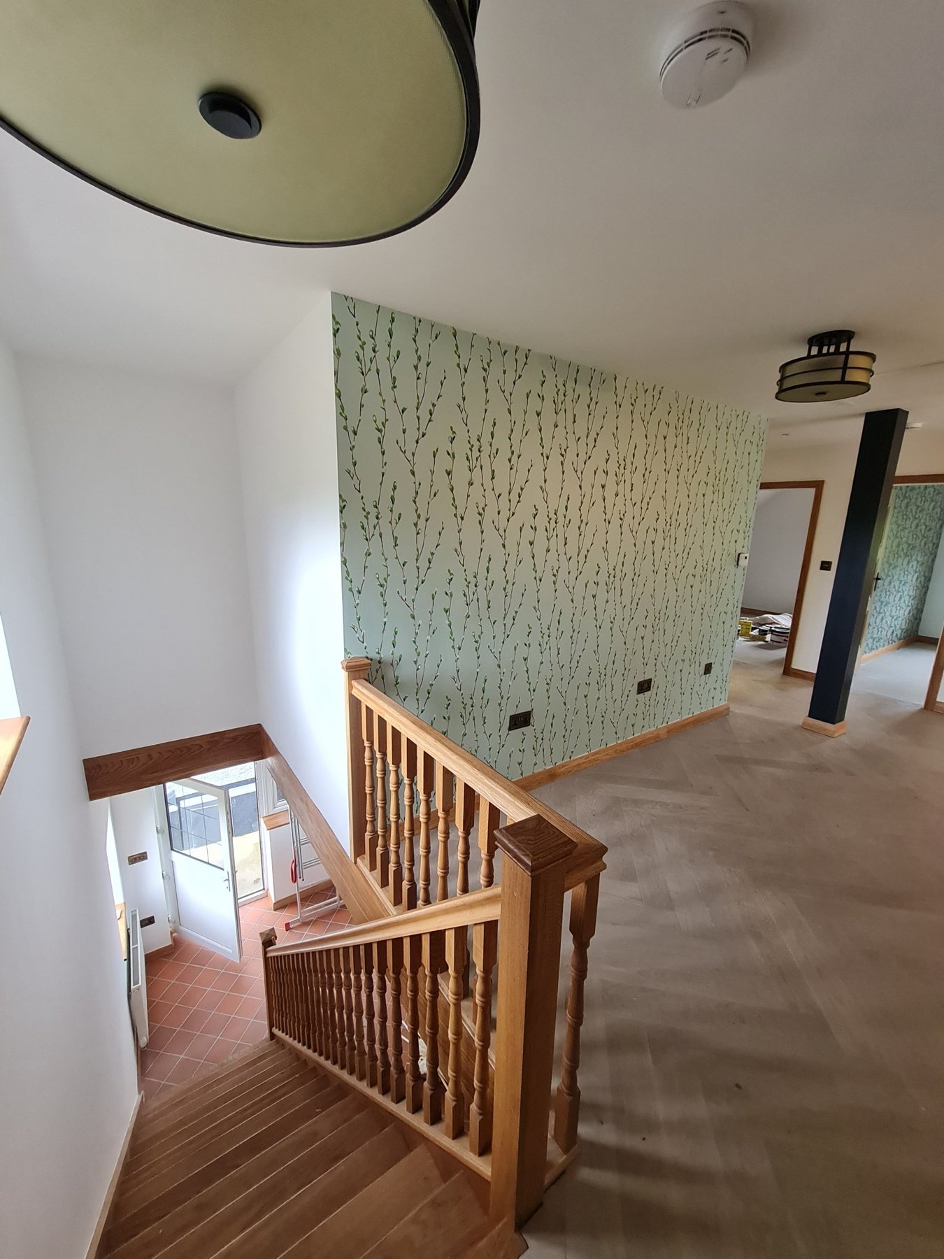 Staircase and landing with willow feature wallpaper and oak balustrade, Conwy annexe