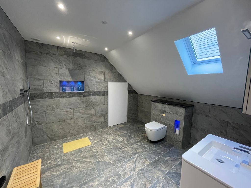 Wet room bathroom with painted ceiling and sloping walls, Conwy annexe