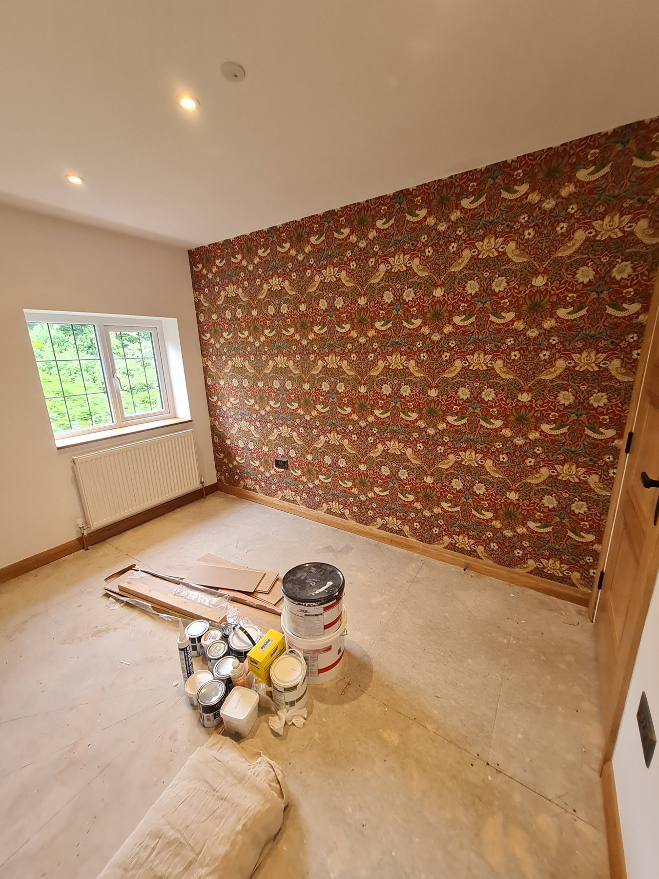 Red feature wallpaper wall and painted walls in second annexe bedroom, Conwy