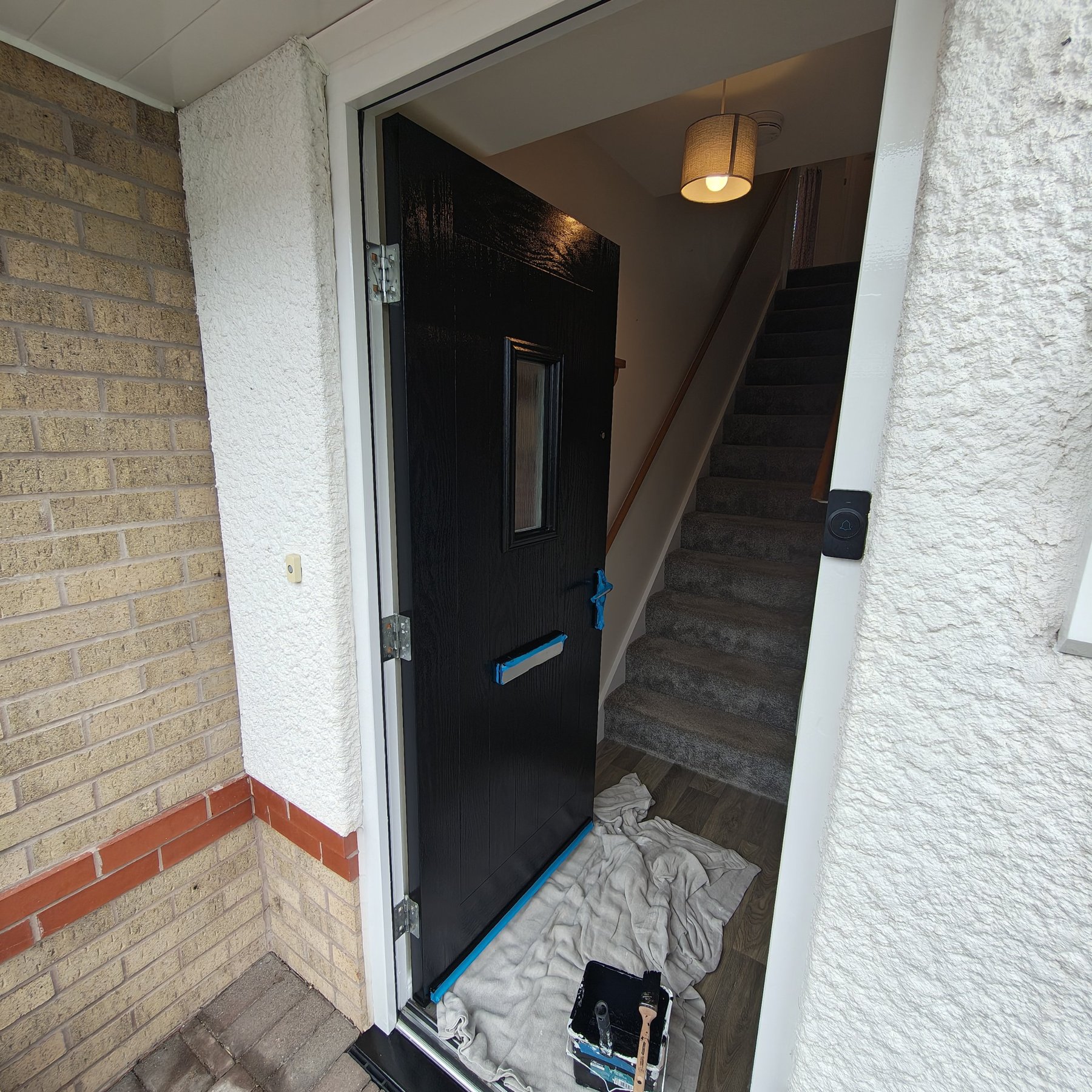 Front door masked and prepared ready for painting by Voss Decorators
