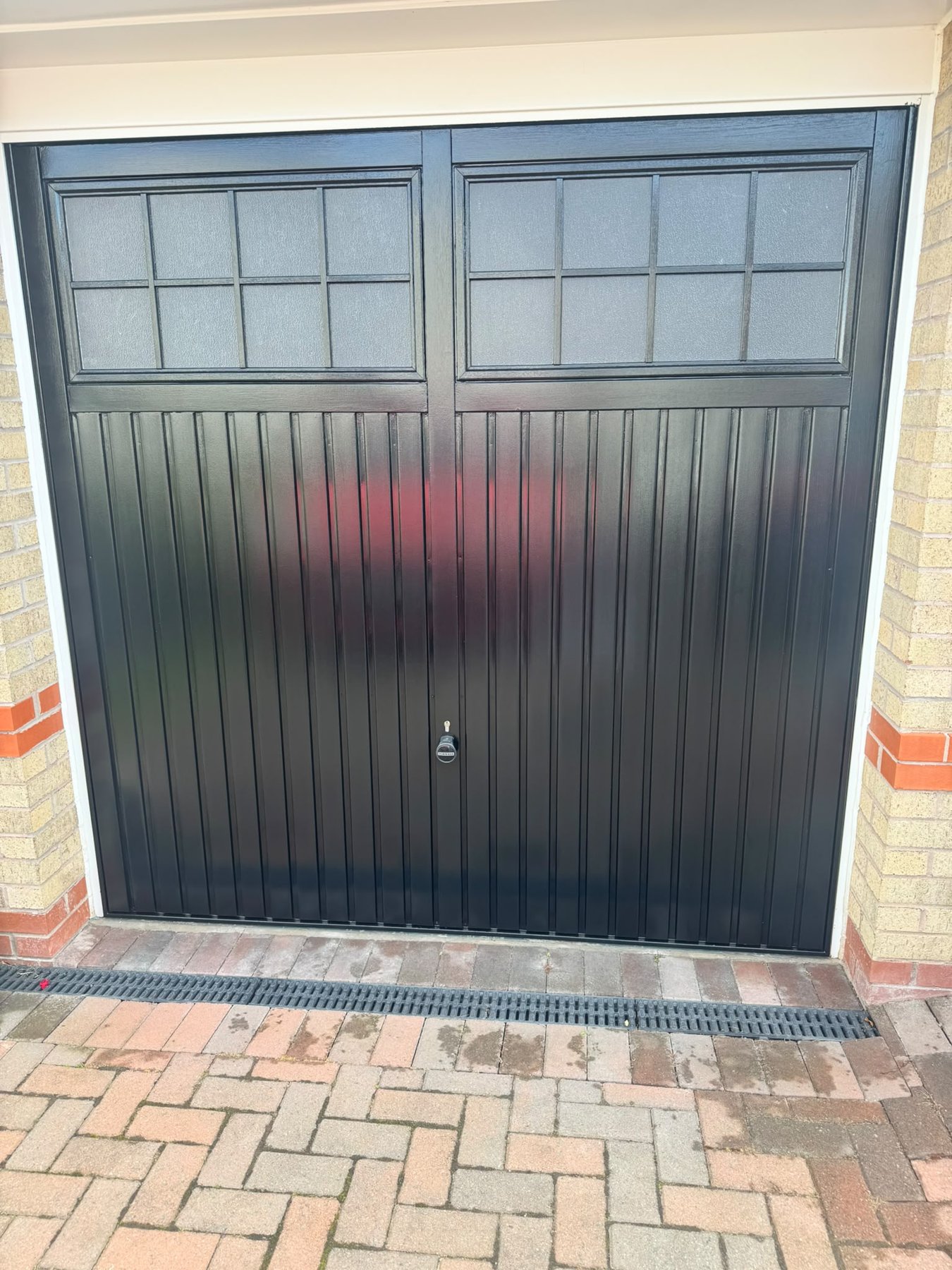 Close up of black gloss finish on a painted garage door