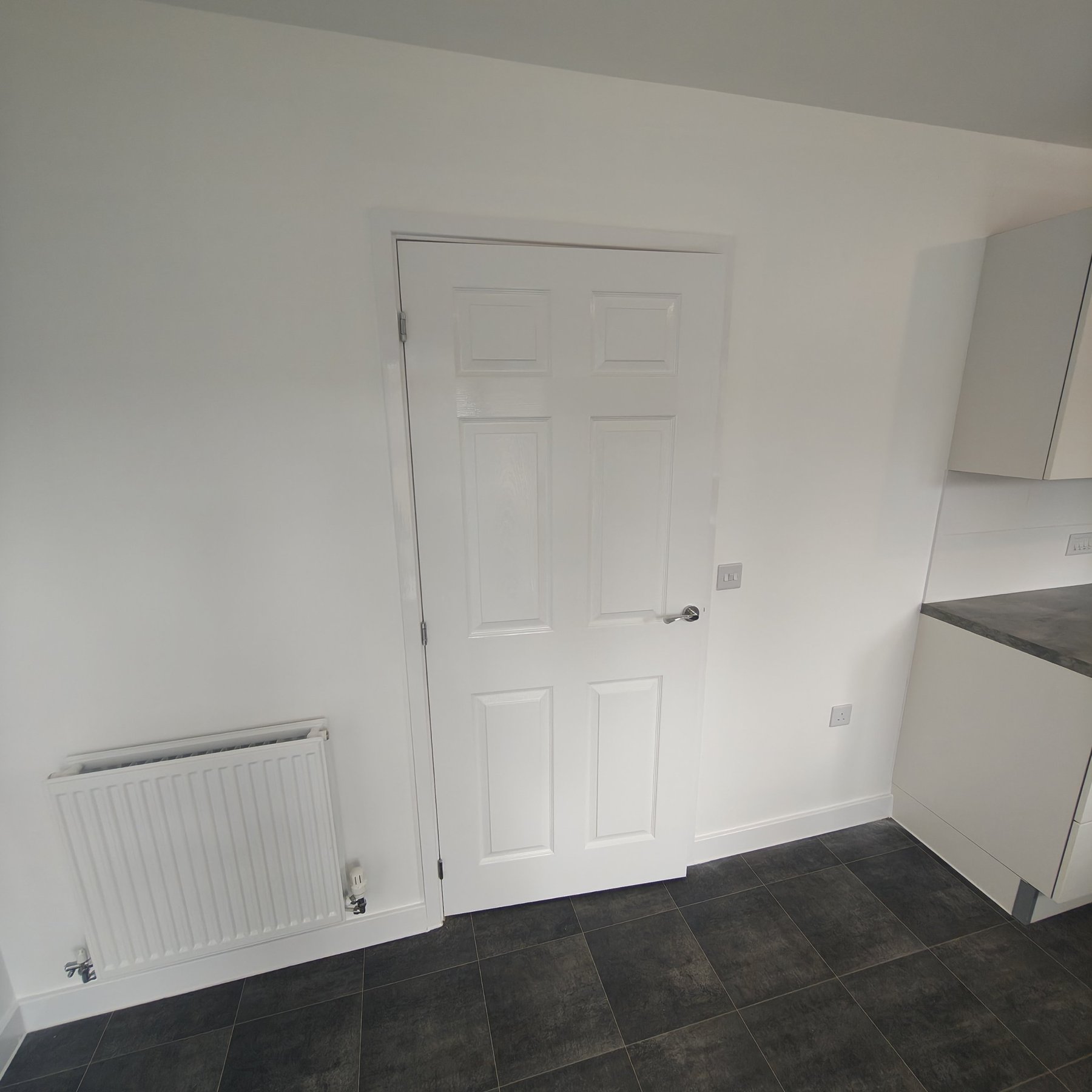 Housing Association Voids, North Wales Kitchen diner with painted walls, gloss door and skirting, housing association void decorating, North Wales