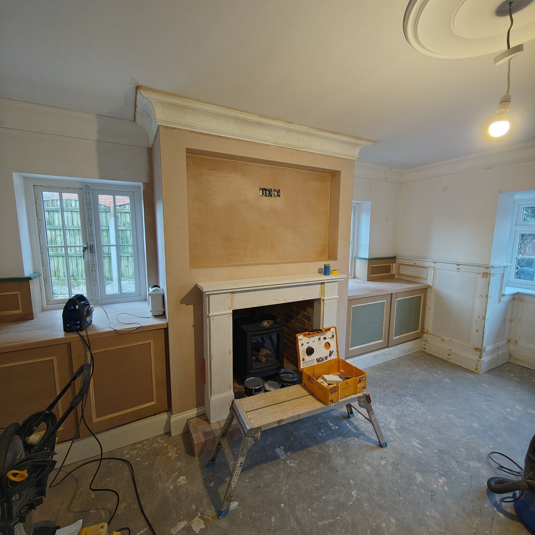 Living room fireplace and alcoves during preparation before decorating, Penrhyn Bay