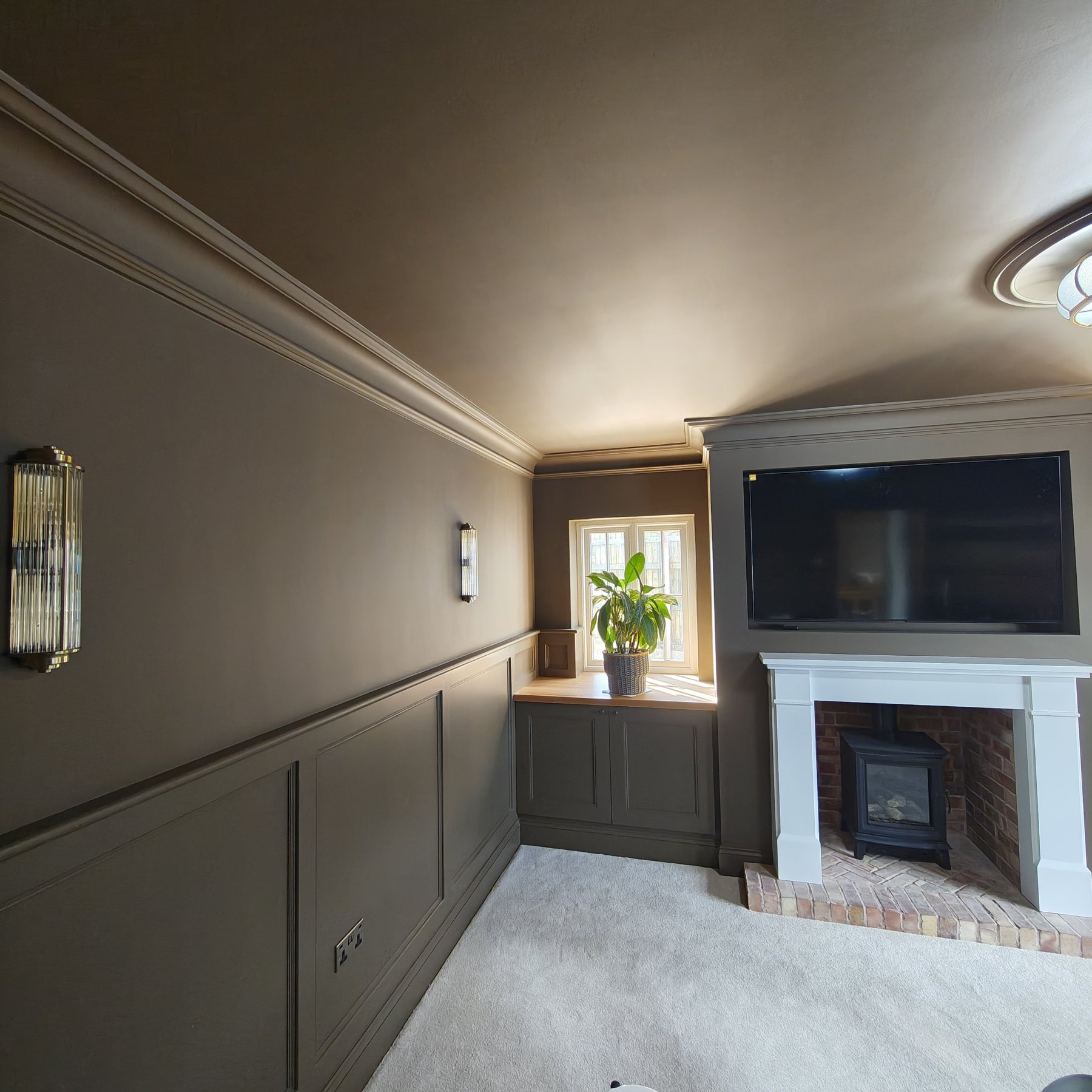 Finished living room with painted panelling, fireplace and alcove cabinets, Penrhyn Bay