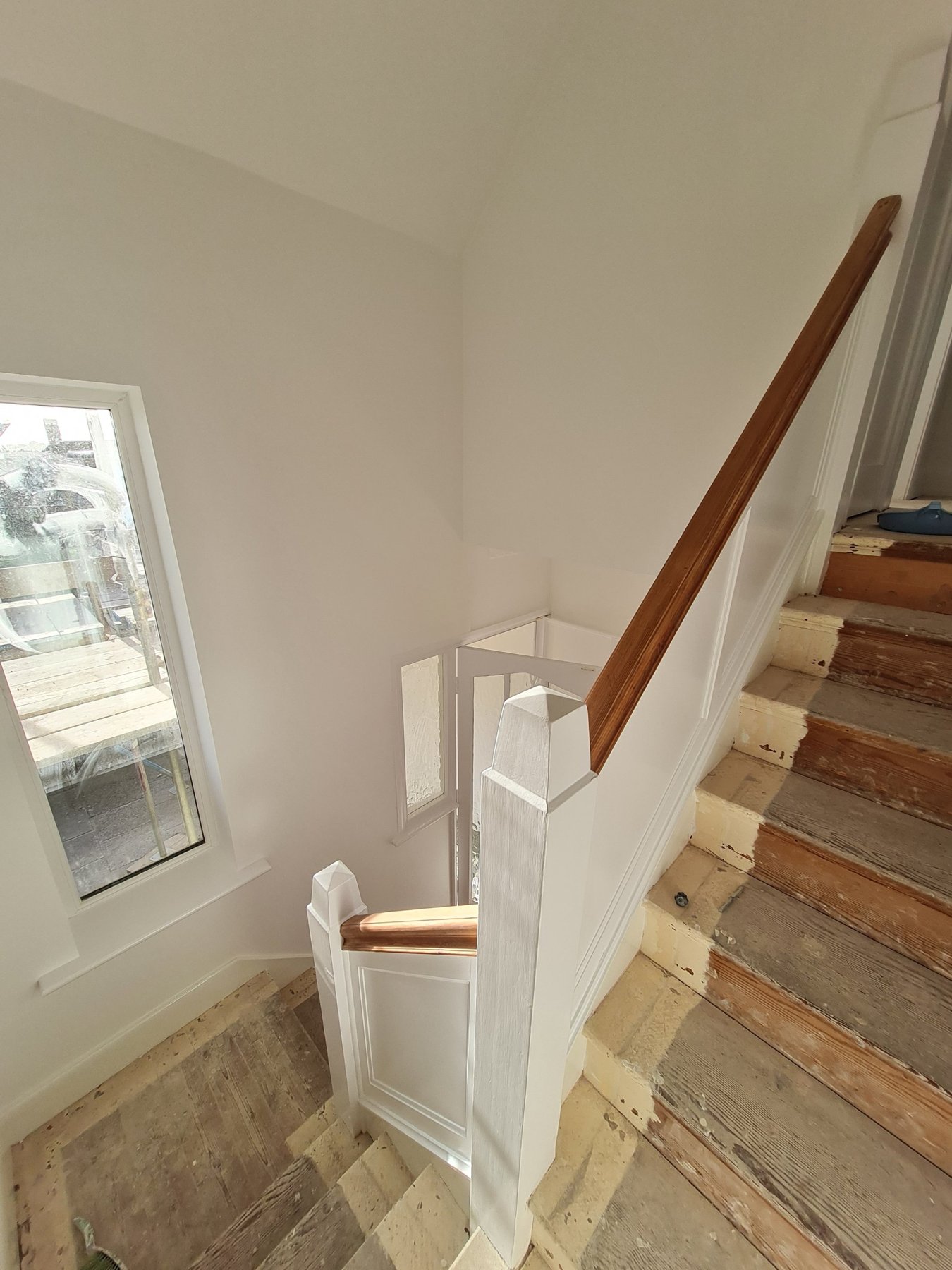 Full Interior Redecoration in Rhyl Staircase panelling and newel posts painted white with stained handrail, Rhyl
