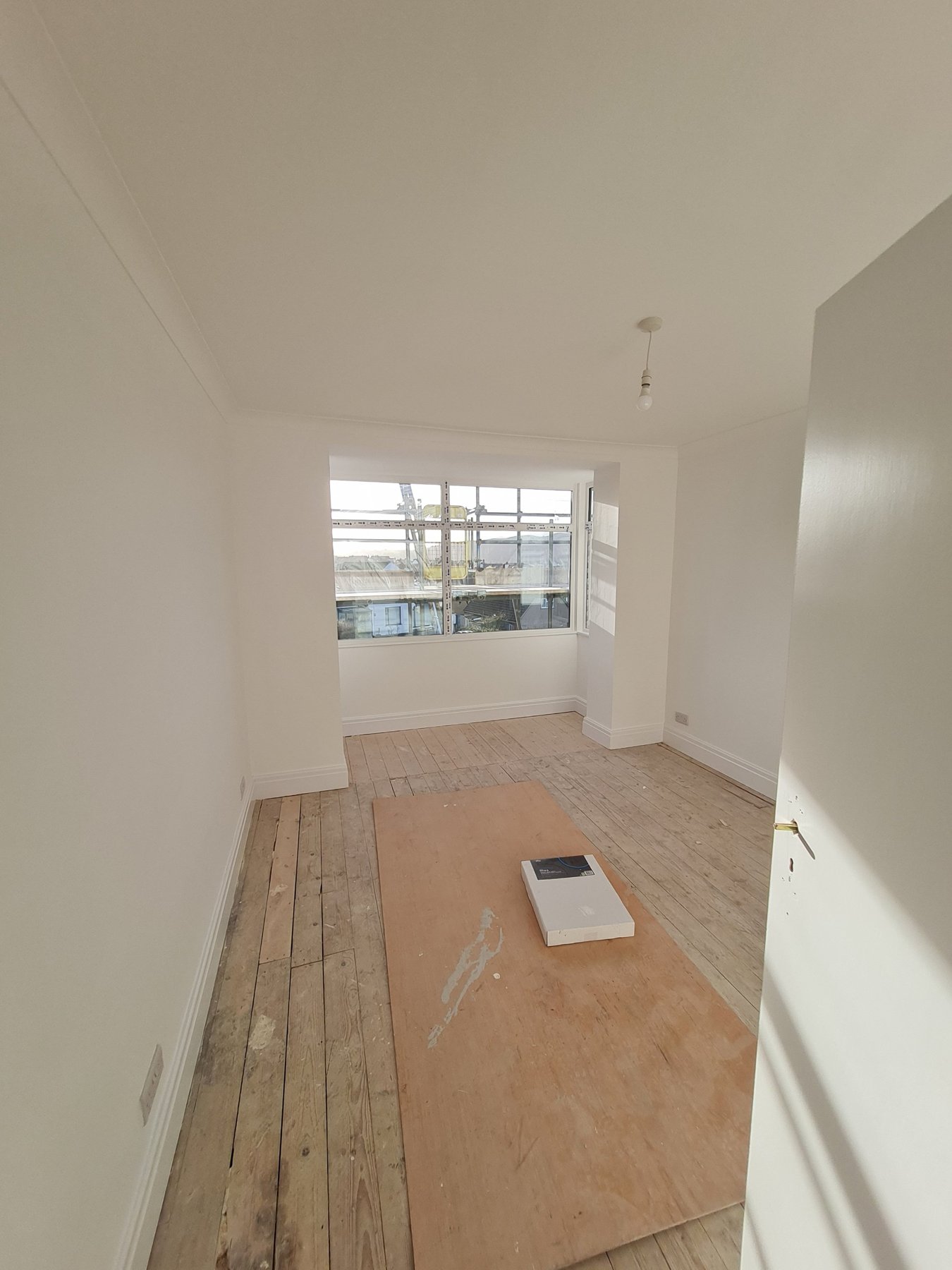 Bedroom with painted bay window, walls and skirting boards, Rhyl